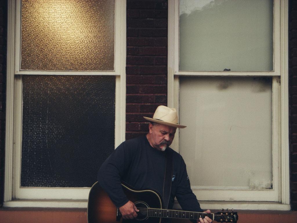 David Ross playing acoustic guitar